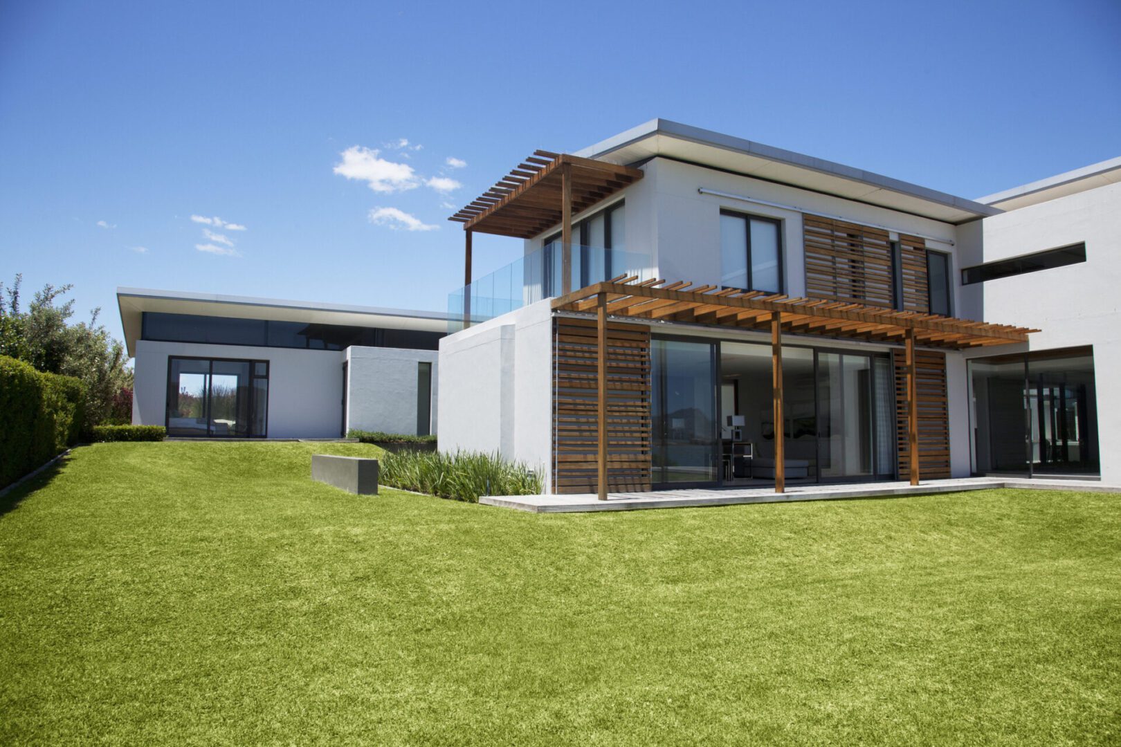 Contemporary home with wooden pergola