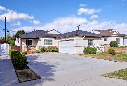 Single-story suburban house with a double garage and driveway.