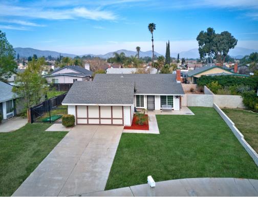 A single-story suburban house with a two-car garage and a spacious front yard.
