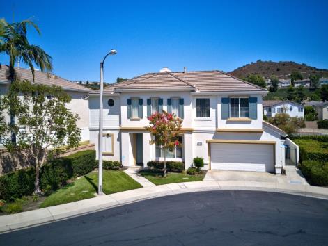 Modern two-story suburban house with a three-car garage.