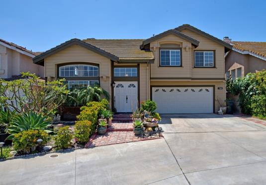 Spacious two-story suburban house with attached garage and well-maintained front yard.