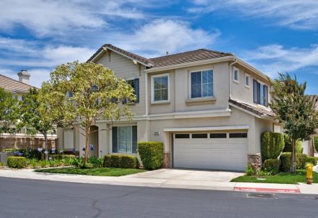 Modern two-story house with a double garage and well-kept landscaping.