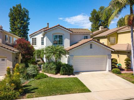 A modern two-story house with a well-maintained lawn and driveway.