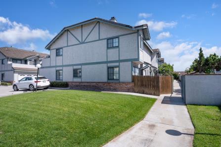 Two-story house with a well-kept lawn and driveway.