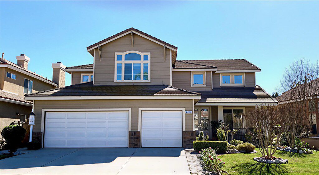 Modern two-story house with garage and landscaped front yard.