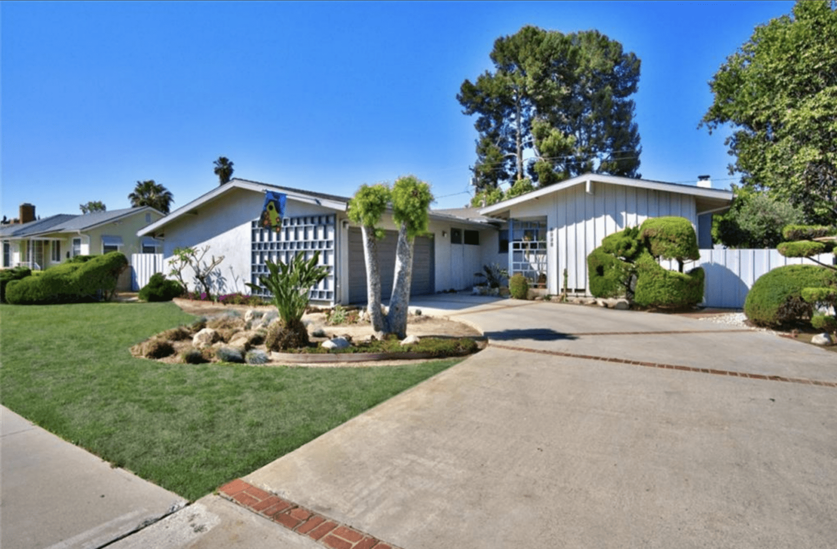 Mid-century modern house with unique architecture and desert landscaping.