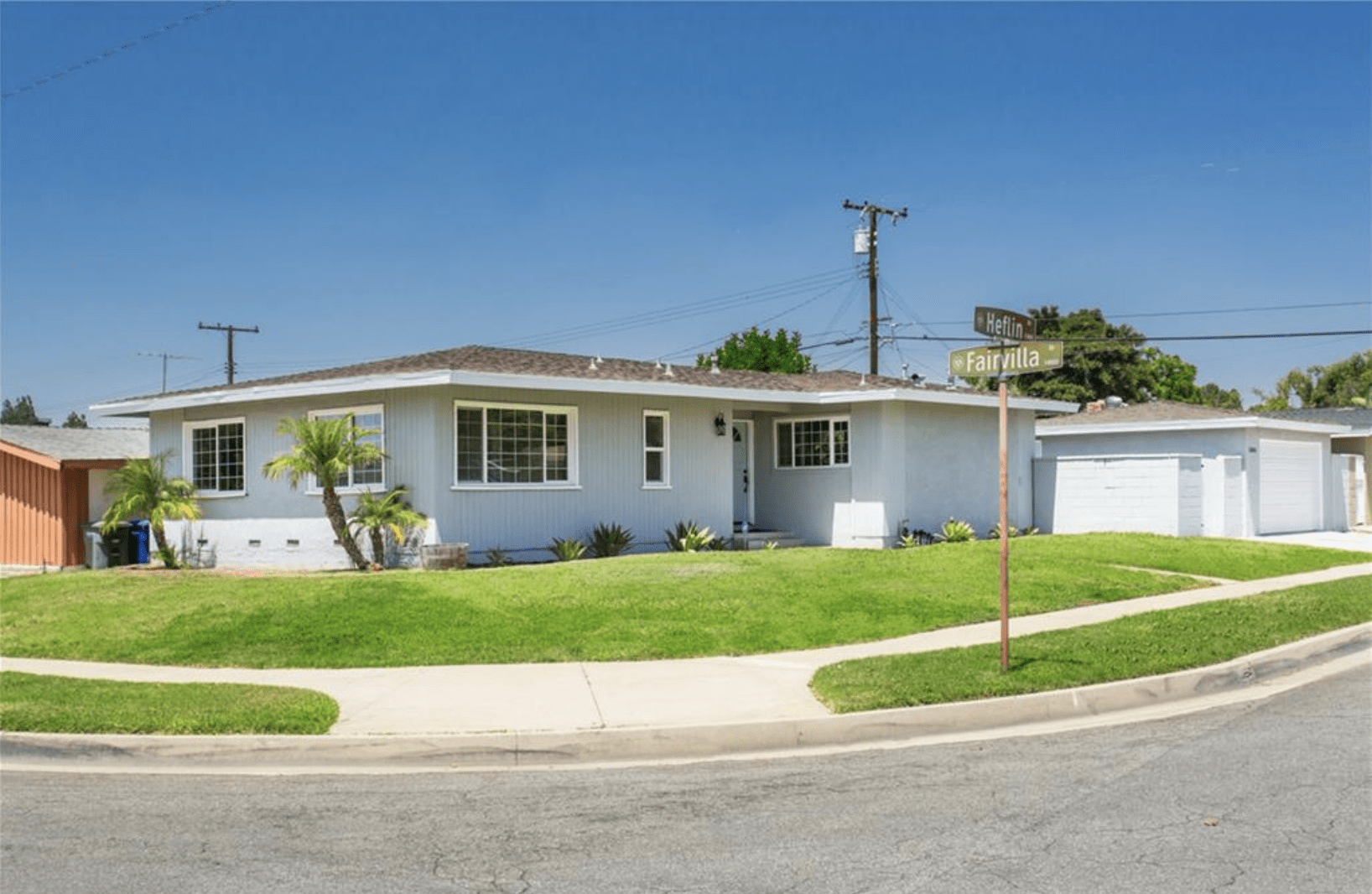 Single-story suburban house with a well-maintained lawn and driveway.